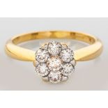 AN 18CT YELLOW GOLD AND DIAMOND CLUSTER RING, the centre claw-set diamond surrounded by six