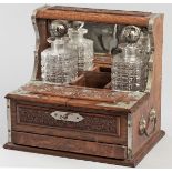 A 19TH CENTURY OAK AND BRASS BOUND TANTALUS, comprising: several compartments and a single pull-