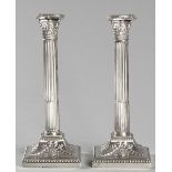 A PAIR OF SILVERPLATE CORINTHIAN COLUMN CANDLESTICKS, with beaded removable wax pans, reeded stem,
