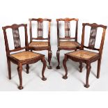 A SET OF FOUR 20TH CENTURY CAPE STINKWOOD DINING CHAIRS, the serpentine top-rails above pierced