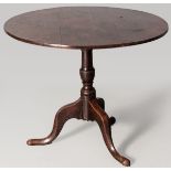 A GEORGE III CIRCULAR OAK TILT-TOP TABLE, the plain top supported on a tilt-mechanism and turned