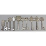 A COLLECTION OF TEN STERLING SILVER PRESENTATION KEYS, of various shapes, sizes and inscriptions,