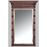 A LARGE GERMAN RECTANGULAR MIRROR, the bevelled plate housed within a carved oak frame, the out-