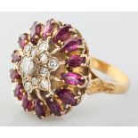 AN 18CT YELLOW GOLD, DIAMOND AND RUBY CLUSTER RING, centre floral set diamonds of approximately 0.