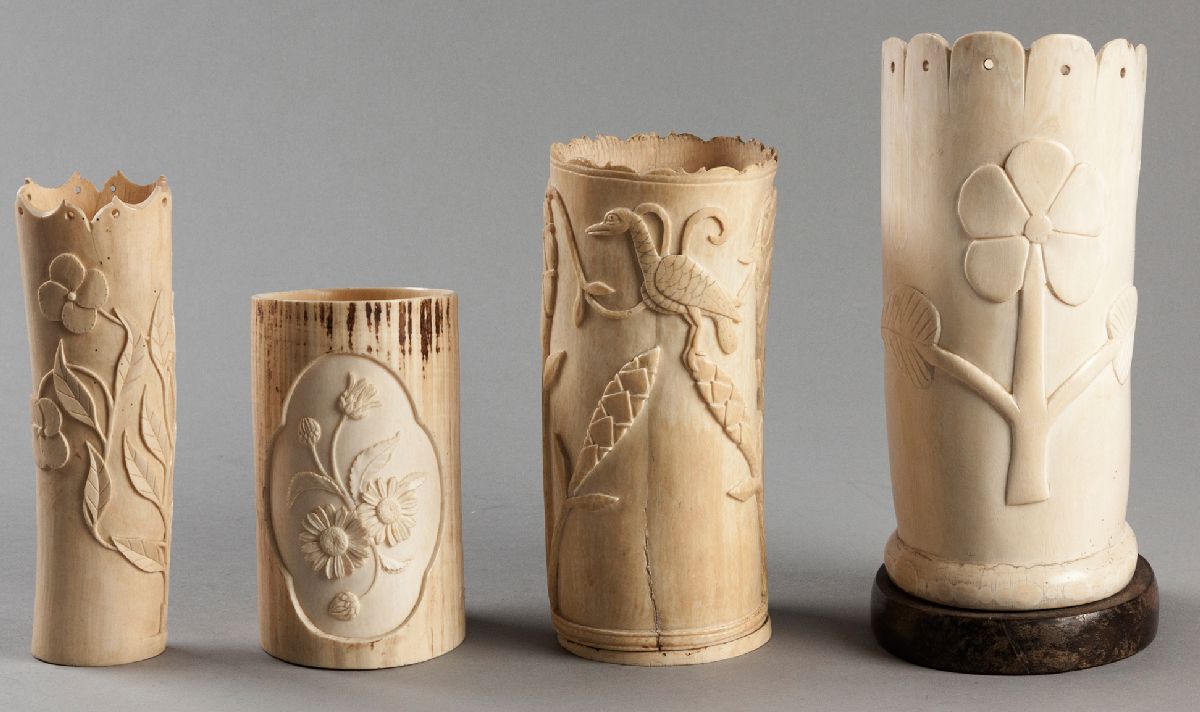 A COLLECTION OF FOUR CARVED AFRICAN IVORY VASES, carved with scenes of birds in foliage and floral
