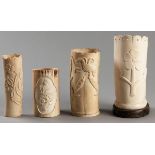 A COLLECTION OF FOUR CARVED AFRICAN IVORY VASES, carved with scenes of birds in foliage and floral