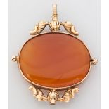 A 14CT YELLOW GOLD AND CARNELIAN PENDANT, the oval-form carnelian set in a gold organic form
