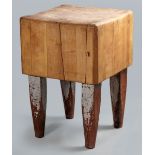 AN EARLY 20TH CENTURY LAMINATED BEECH BUTCHER'S BLOCK, the square top standing on square and