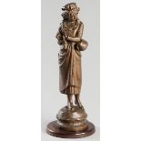 HENRI WEISSE ATTRIB. (FRENCH: 19TH CENTURY), MAIDEN KNITTING, spelter, standing on a circular wooden