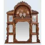 A CARVED EDWARDIAN OVER-MANTEL MIRROR, the elliptical sunburst top above a rectangular mirror