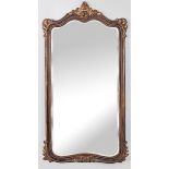 A RECTANGULAR GILT FRAMED BEVELLED MIRROR, with scalloped top and bottom edges, set in a partly