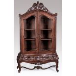 A 20TH CENTURY ORIENTAL HARDWOOD DISPLAY CABINET, the moulded arched top rested with an eagle and