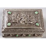 A THAI SILVER CASKET, the hinged top embossed with a court scene, scrolls and swags, inset with jade