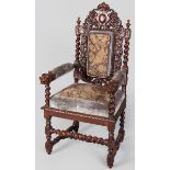 A CARVED OAK RENAISSANCE-STYLE ARMCHAIR, EARLY 20TH CENTURY, the pierced floral carved back