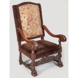A 20TH CENTURY OAK HIGH-BACK ARMCHAIR, covered in deep-brown velvet and needlework, the heavy