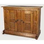 A 19TH CENTURY GERMAN OAK CUPBOARD, the moulded top above two fret-carved rectangular doors and