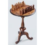 A VICTORIAN WALNUT CIRCULAR CHESS TABLE, the top with a checker board in various woods with a floral