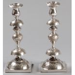 A PAIR OF SILVERPLATE SHABBAT CANDLESTICKS, the removable wax pans embossed with flowers and