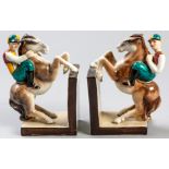 A PAIR OF GOLDSCHEIDER BOOKENDS, moulded in the form of jockeys on horses, bases signed, 20cm (