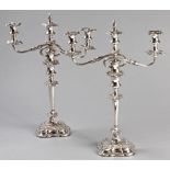 A PAIR OF SILVERPLATE THREE BRANCH CANDELABRA, the removable branch adorned with a removable flame