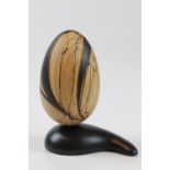 Betty Scarpino (USA) Spalted beech carved egg on plinth 13x10cm. Signed
