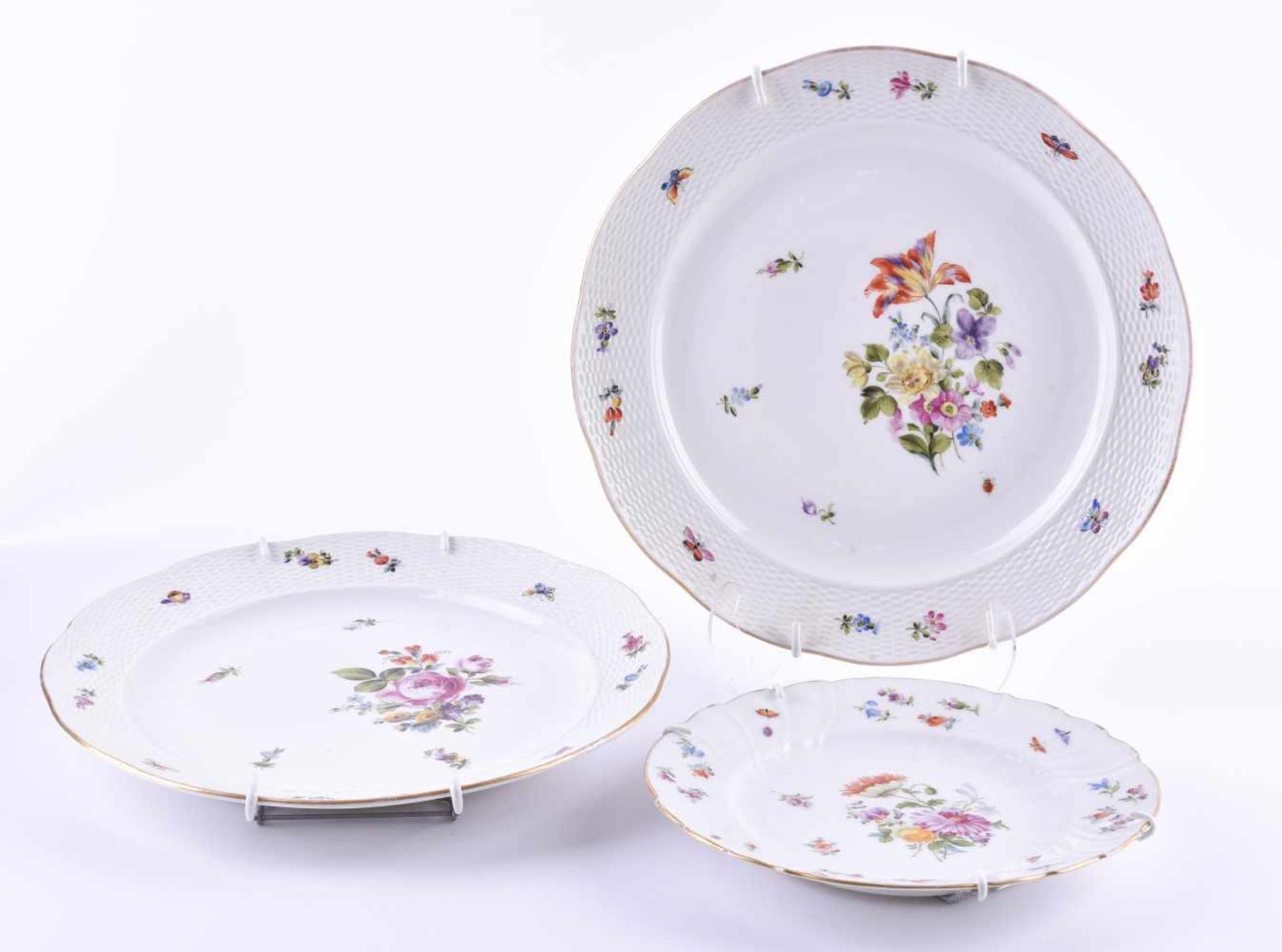 3 plates Ungvarer around 1850colorfully decorated with floral and butterfly decoration, all with