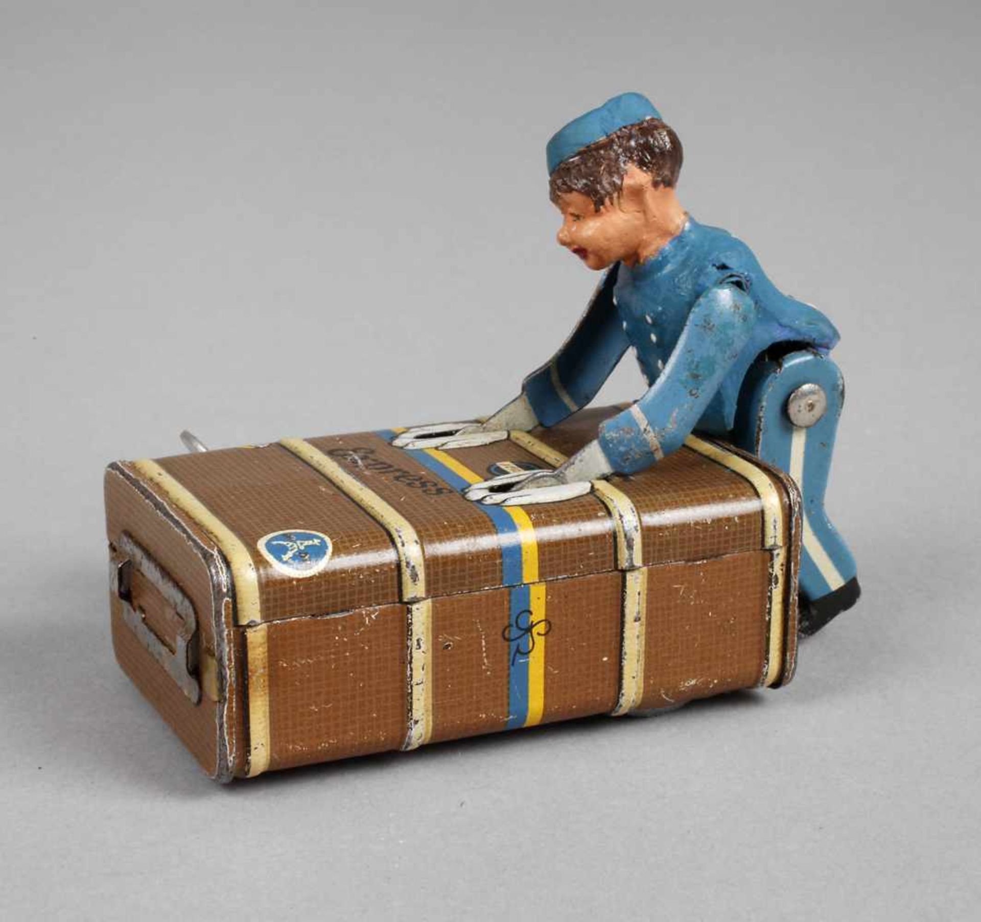 Kofferträger Gescha1930er Jahre, Blech farbig lithografiert, mit Uhrwerk und passendem Schlüssel,