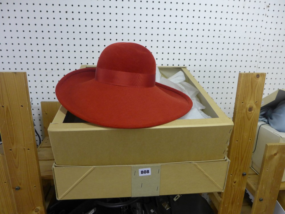 A 1970 style wide brim red Christian Dior hat, with box [upstairs shelves] FOR DETAILS OF ONLINE