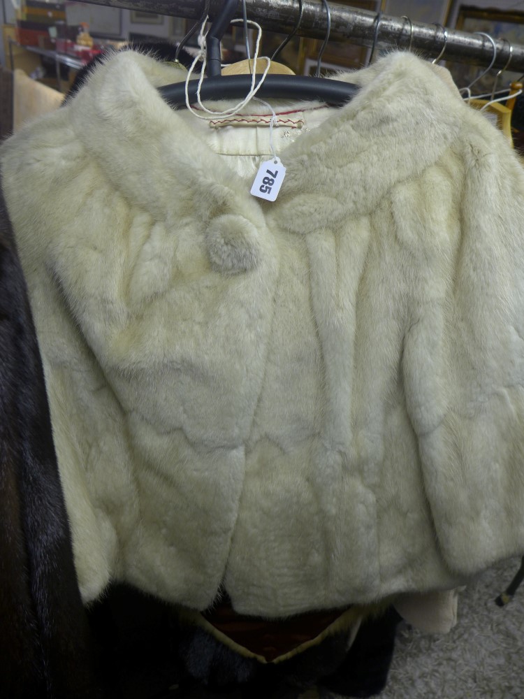 A lady's ivory musquash fur cropped jacket with three-quarter length sleeves, and a fox fur shrug [