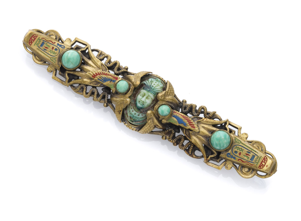 BROOCH OF EGYPTIAN TASTE in gilded metal and enamels with acrylic stones. Central stone with small