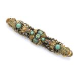 BROOCH OF EGYPTIAN TASTE in gilded metal and enamels with acrylic stones. Central stone with small