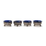 FOUR SILVER SALT CELLARS, PUNCH BIRMINGHAM 1876 fluted body and sphere footsies. Interior in blue