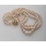 ATTRACTIVE NECKLACE three threads in white coral with pink tones Clasp in gold 18 kts. Length cm.