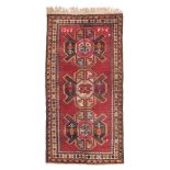 KARABAGH CARPET, DATED 1960 gul design with animals in the center field on red ground. Measures