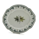 MAIOLICA DISH, PROBABLY FAENZA 19TH CENTURY in white and green enamel decorated with ivy leaves.