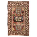 KAZAK CARPET, LATE 19TH CENTURY triple geometric medallion with stars and secondary motifs of