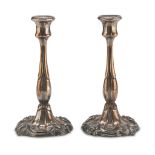 A PAIR OF SILVER-PLATED CANDLESTICKS, 20TH CENTURY with leafy shaft and floral scroll base. Measures