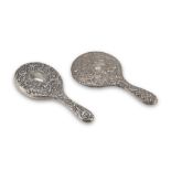 TWO HAND MIRRORS IN SILVER, PUNCH LONDON 1906 embossed with floral motifs. Silversmith C.D. Title