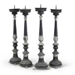 FOUR METAL CANDLESTICKS, SOUTHERN ITALY 19TH CENTURY black lacquered, claw feet. h. cm. 66. Defects.