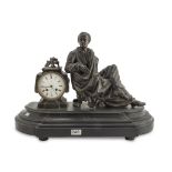 TABLE CLOCK IN ANTIMONY, LATE 19TH CENTURY black patina, with figure of Montesquieu beside the dial.