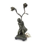 TWO-BRANCHED BRONZE CANDELSTICK, 19TH CENTURY of black patina, shaft with figure of cherub