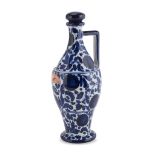 FLASK IN CERAMICS, FAENZA '30s in white and blue enamel, with floral decorums. Mark under the