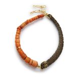 FANTASY CHOKER with elements in pink coral and horn engraved with stylized floral motifs. Hammered