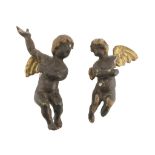 REMAINS OF TWO SMALL CHERUB SCULPTURES, 18TH CENTURY in brown and gold lacquered wood. Measures