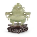VASE IN JADE, CHINA 20TH CENTURY with sphere body with tripod support and dragon head handles. Cover