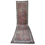 HAMADAN RUNNER, EARLY 20TH CENTURY with medallion in blue and secondary motifs of branches with