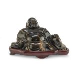SCULPTURE IN TIGER'S EYE, CHINA 20TH CENTURY representing sitting Budai. Measures cm. 8 x 12 x