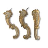 THREE WALL ARMS IN LACQUERED WOOD, 18TH CENTURY with double scrolls, sculpted to leaves and curls.