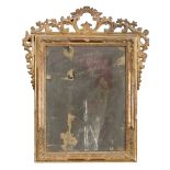 GILTWOOD MIRROR, CENTRAL ITALY 18TH CENTURY with molded frame and frieze of scrolls, leaves and