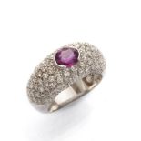 SPLENDID RING in white gold 18 kts., band shaped with central ruby and studded with diamonds. Ruby